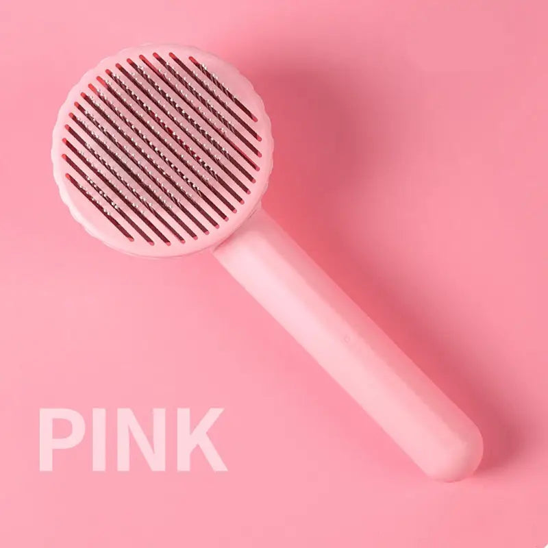 Peigne à chat - Design ergonomique, toilettage essentiel : Brosse rose pour enlever les poils morts sur fond rose